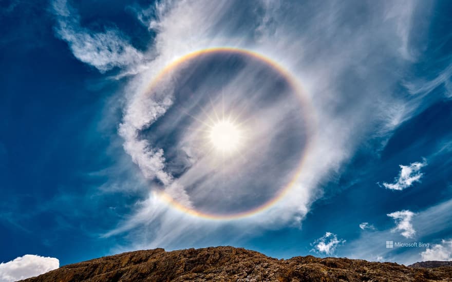 Sun halo over Lake Antermoia in the Dolomite Mountains of Italy